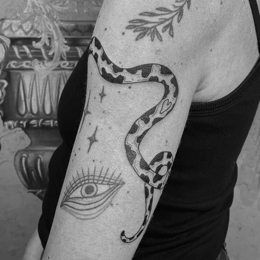 Medium Illustrative Snake Eye Stars Tattoo on Women Arm by @chrsrzvn.ink