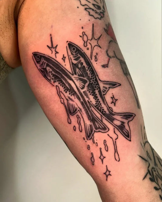 Medium Illustrative Two Fish With Stars Tattoo on Men Arm by @clown.collegiate