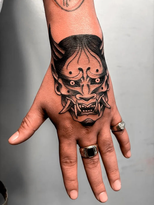 Medium Irezumi Oni Mask on Men Hand Tattoo by @jadeddesireetattoo