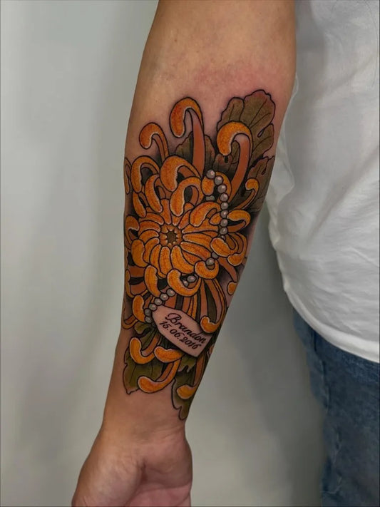 Medium Irezumi Orange Chrysanthemum with Pearls and Ribbon Tattoo on Men Arm by @sammiejtattoo
