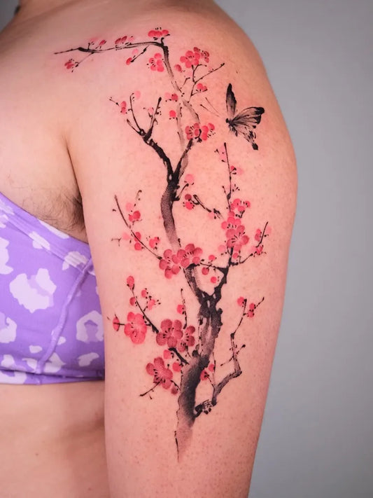 Medium Japanese Cherry Blossom Butterfly on Women Shoulder Tattoo by @maobi.tattoo
