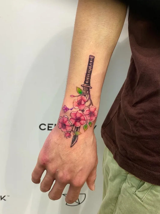 Medium Japanese Cherry Blossom and Sword on Men Wrist Tattoo by @dom_macio_tattoo