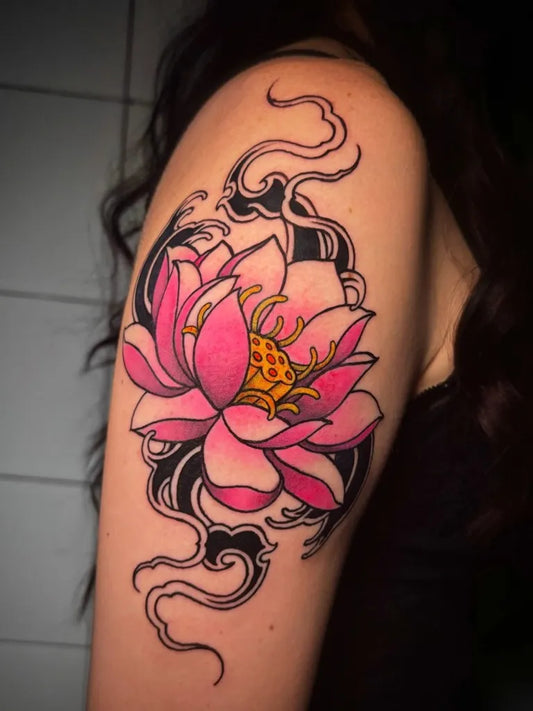 Medium Japanese Lotus Flower with Tribal Clouds on Women Shoulder Tattoo by @francescoracioppa_