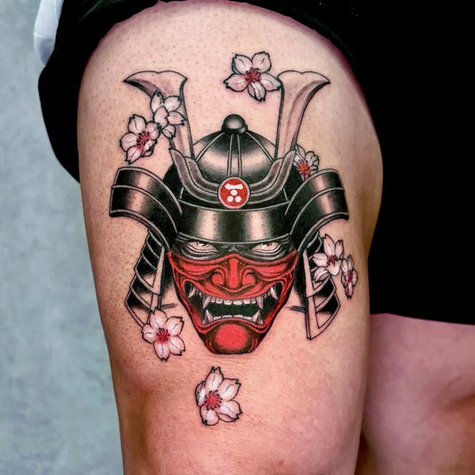 Medium Japanese Oni Mask with Cherry Blossoms and Kabuto on Men Thigh Tattoo by @mako.tattoo_tokyo