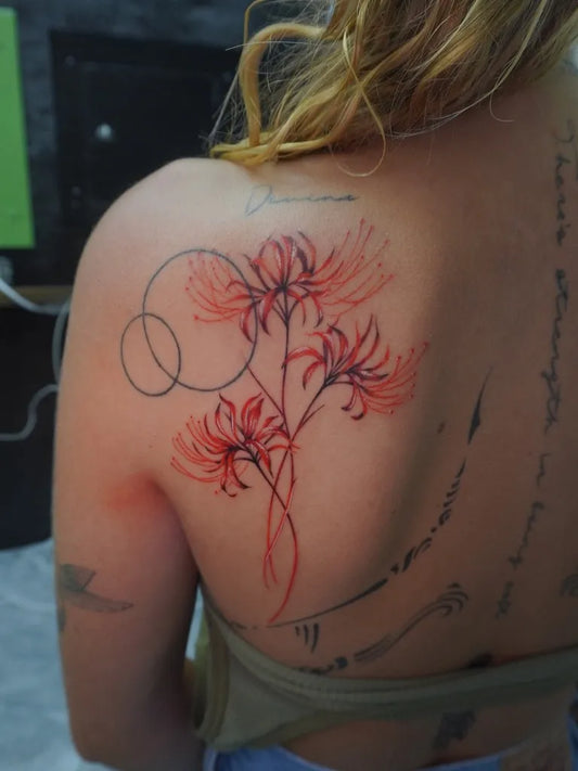 Medium Japanese Spider Lily Red and Circles Tattoo on Women Shoulder by @haze.tattoostudio