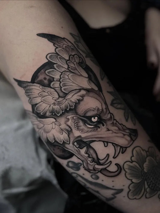 Medium Japanese Wolf with Wings and Flowers on Women Arm Tattoo by @scallywaggins