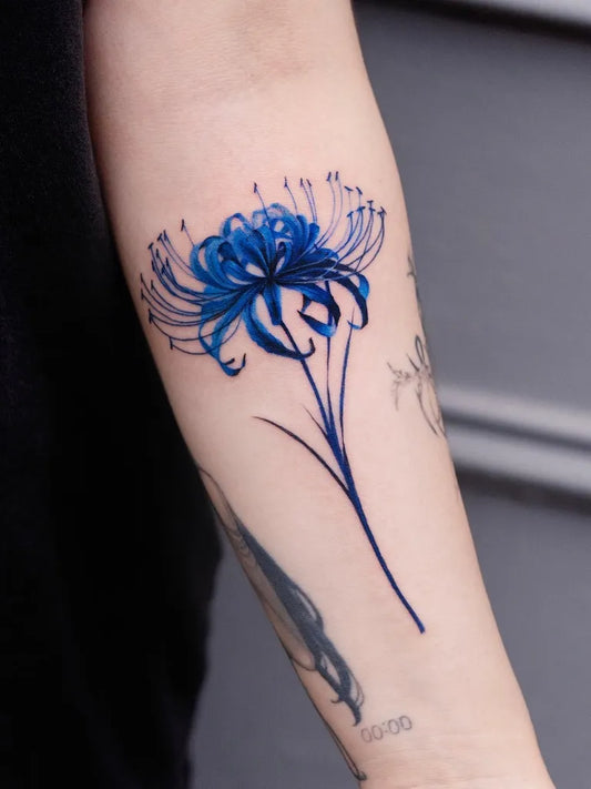 Medium Linework Blue Spider Lily Tattoo on Women Arm by @pokhy_tattoo