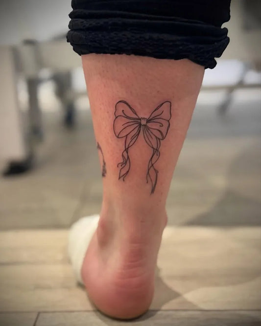 Medium Linework Bow on Women Ankle Tattoo by @inked_byjaz_