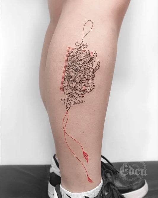 Medium Linework Chrysanthemum in Black and Red Box String Tattoo on Women Thigh by @eden_tattoos