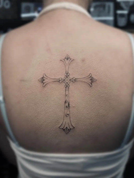 Medium Linework Cross on Women Back Tattoo by @ratatat.tattoo