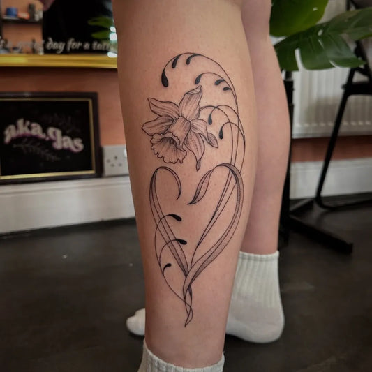 Medium Linework Daffodil and Vines Tattoo on Women Leg by @aka.jas
