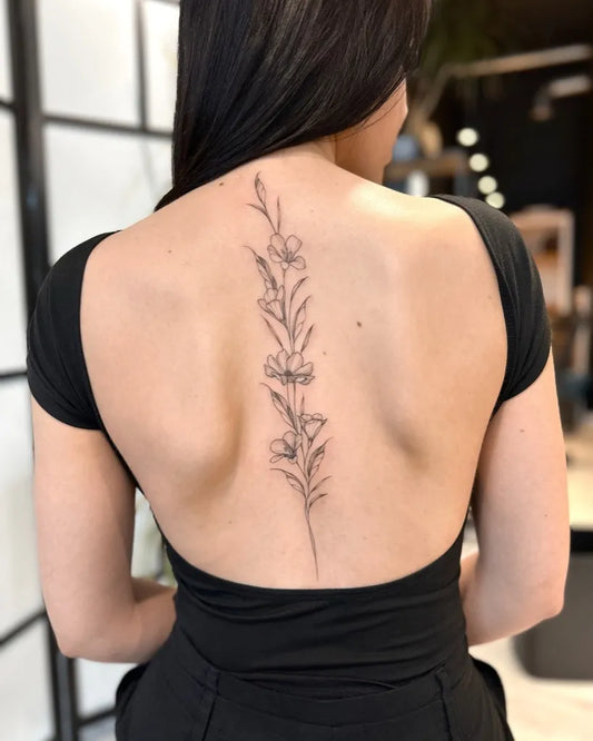 Medium Linework Flowers on Women Back Tattoo by @zajawatattoo_gda