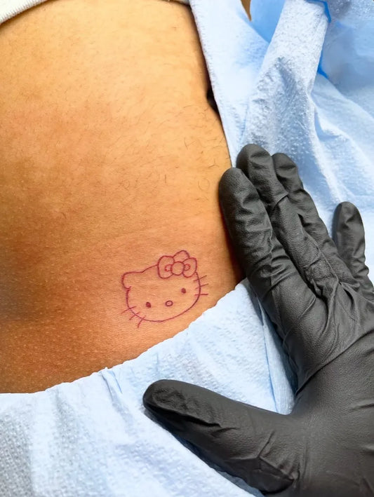 Medium Linework Hello Kitty on Women Hip Tattoo by @inkatorymiami