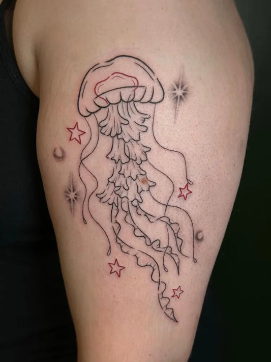 Medium Linework Jellyfish and Stars Tattoo on Women Upper Arm by @poppy.tattoos