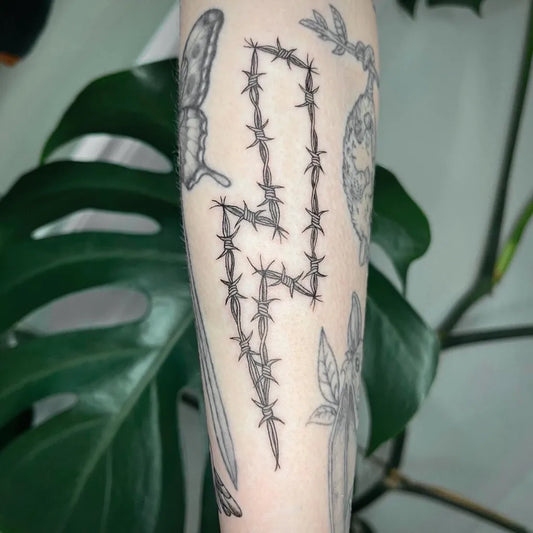 Medium Linework Lightning Bolt Barbed Wire Butterfly Tattoo on Women Arm by @admirable.aura