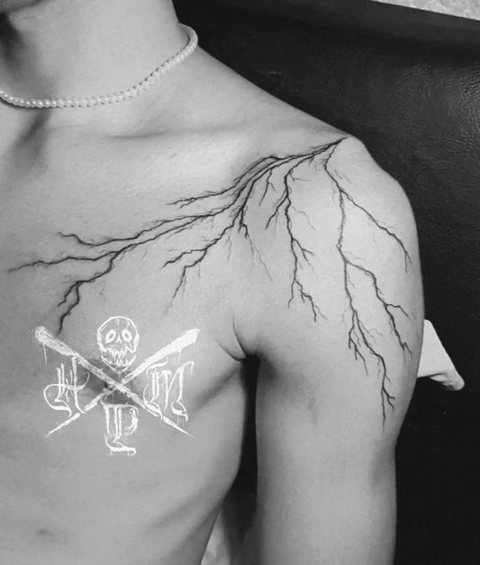 Medium Linework Lightning Bolt Skull Tattoo on Men Shoulder by @hiro.munster.tattoo