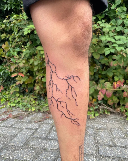 Medium Linework Lightning Tattoo on Men Thigh by @darkline.tattoo.studio