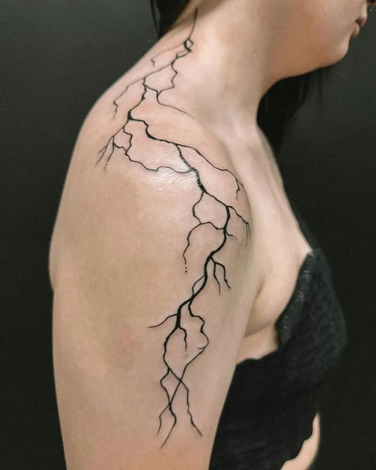 Medium Linework Lightning Tattoo on Women Shoulder by @hybridink.helsinki