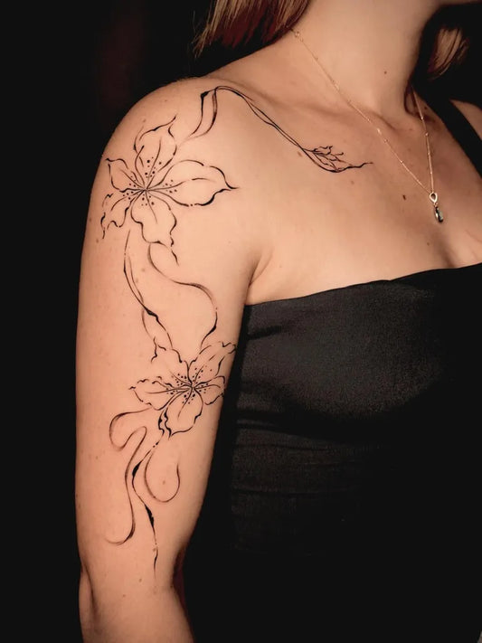 Medium Linework Lilies and Vines on Women Shoulder Tattoo by @86.inked
