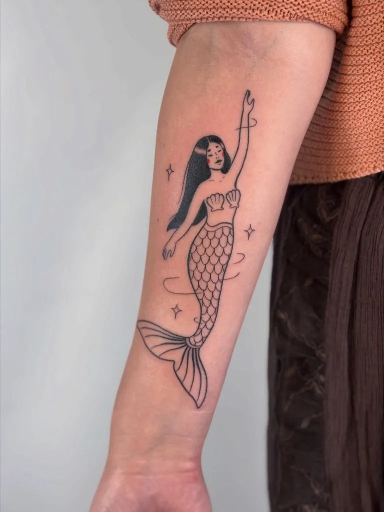 Medium Linework Mermaid Tattoo on Women Arm by @justinecrawfart