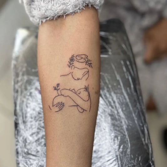 Medium Linework Motherholdingchild on Women Arm Tattoo by @ubinktattoos