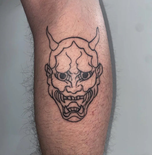 Medium Linework Oni Mask on Men Leg Tattoo by @kat.tattoos