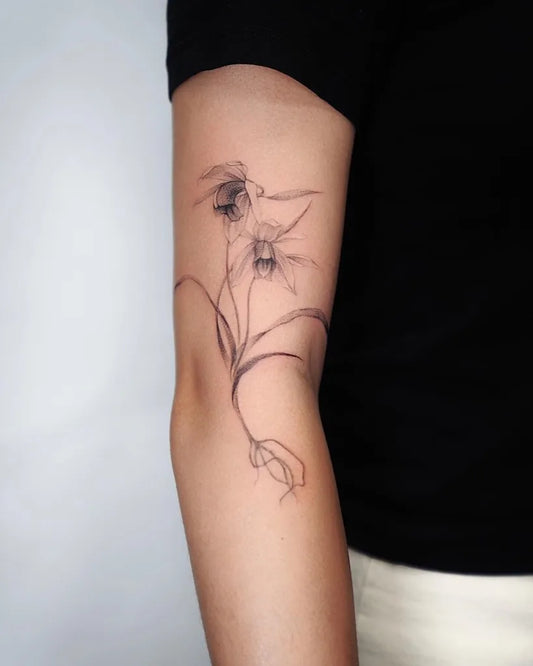 Medium Linework Orchid Tattoo on Women Arm by @baronarttattoo
