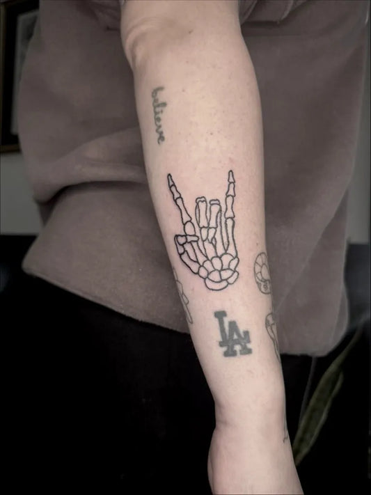 Medium Linework Skeleton Hand Tattoo on Women Arm by @tattooed.bytiny