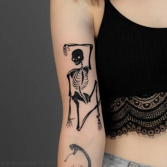 Medium Linework Skeleton Tattoo on Women Arm by @blackhousetattoo