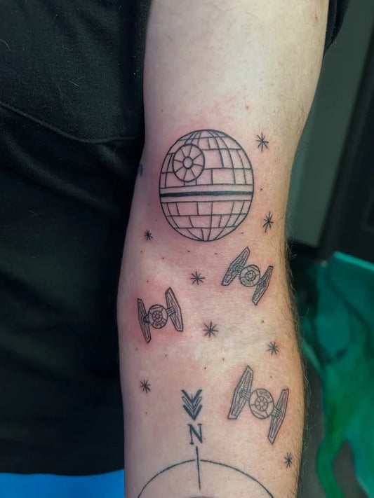 Medium Linework Star Wars Death Star and TIE Fighters Tattoo on Men Arm by @maggiemaytattoo