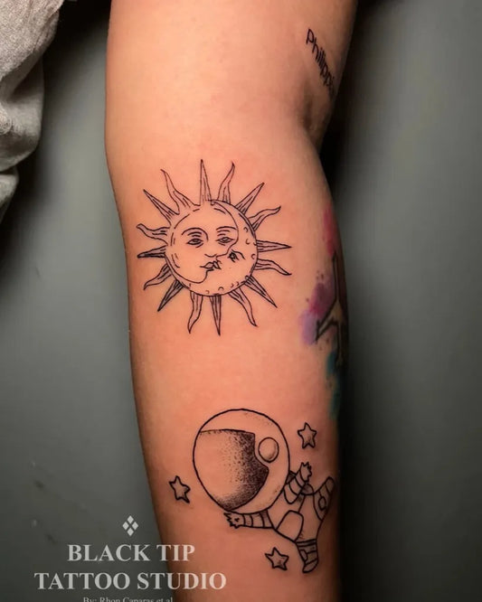 Medium Linework Sun Astronaut and Stars on Women Arm Tattoo by @blacktiptattstudio