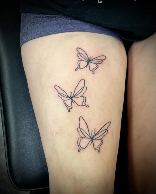 Medium Linework Three Butterflies on Women Thigh Tattoo by @inkedbyslice