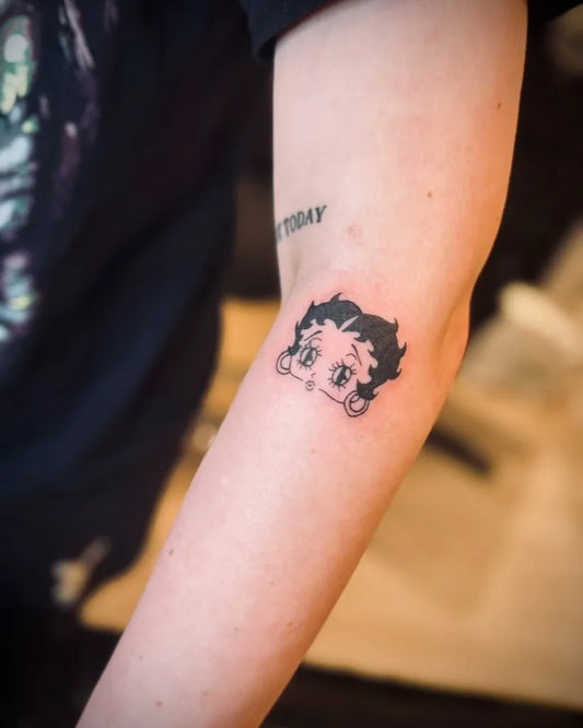 Medium Minimalist Betty Boop on Women Arm Tattoo by @inked_byjaz_