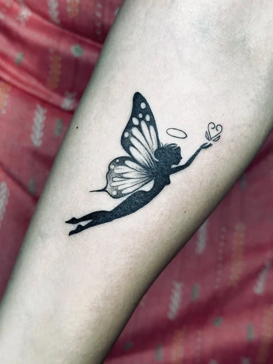 Minimalist Fairy with halo and heart on Women Forearm Tattoo by @ajtattoopune