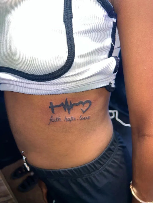 Medium Minimalist Heartbeat Cross Heart on Women Side Tattoo by @official_ink_lab_