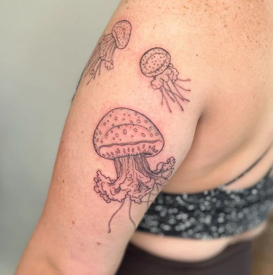 Medium Minimalist Jellyfish Tattoo on Women Arm by @seed.eternal