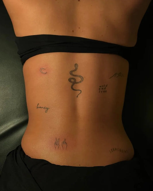 Medium Minimalist Snake Lucy on Women Back Tattoo by @leonhard.ink