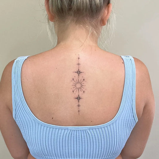 Medium Minimalist Sun Spine on Women Back Tattoo by @fox.inkstudio