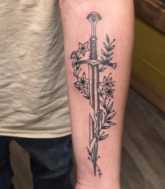 Medium Narsil Sword with Flowers and Leaves on Men Arm Tattoo by @xxaida.dahliaa
