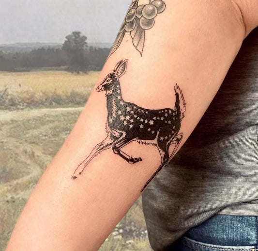 Medium Negative Space Deer Tattoo on Women Arm by @hemlocktattoostudio