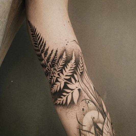 Medium Negative Space Fern Tattoo on Women Arm by @lynn.ivarsson