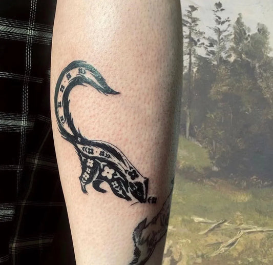 Medium Negative Space Skunk Tattoo on Women Forearm by @hemlocktattoostudio