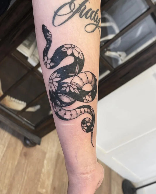 Medium Negative Space Snake Tattoo on Women Arm by @karrigan.ink