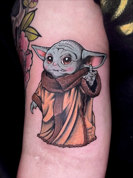 Medium Neo Traditional Baby Yoda Star Wars Tattoo on Women Arm by @derek_tattoo