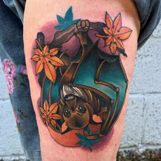 Medium Neo Traditional Bat with Maple Leaves Tattoo on Women Arm by @kimberlytattoo