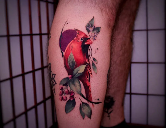 Medium Neo Traditional Cardinal with Flowers Tattoo on Men Leg by @the.golden.siren