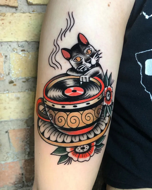 Medium Neo Traditional Cat Cup Vinyl Music Tattoo on Women Arm by @isasantanatattoo