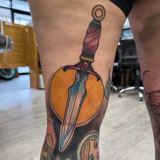 Medium Neo Traditional Dagger and Sun Tattoo on Women Thigh by @joshbudgentattoos