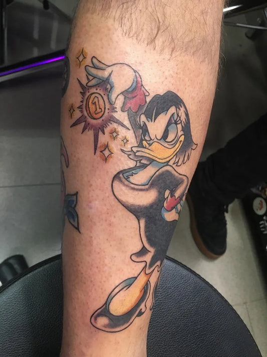 Medium Neo Traditional Donald Duck Cartoon Tattoo on Men Leg by @maisiecarter_tattoo