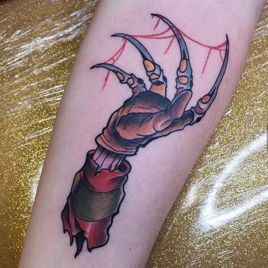 Medium Neo Traditional Freddy Krueger Gloved Hand Horror Tattoo on Men Arm by @goldenmoosetattoo